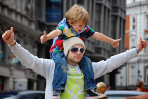 Photo of a man with a little boy on his shoulders