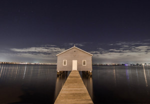 Photo of a house on a pier at night