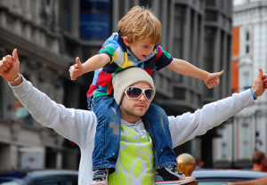 Photo of a man with a little boy on his shoulders