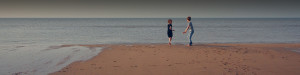 Photo of two kids playing by the shoreline