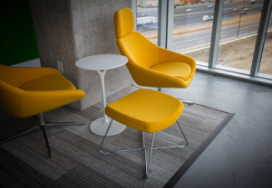 Photo of a modern white table surrounded by bright yellow chairs