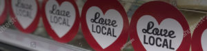 Photo of a red circle with the text of "Love Local" in a white heart