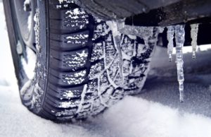 Photo of icicles and snow on a car's tire