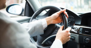 Photo of man turning his steering wheel