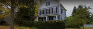 Image of a New England style house in the fall with dark overlay