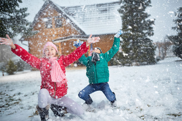 Image of two kids playing in the snow