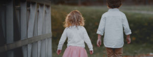 A life insurance photo of a young girl and boy walking together
